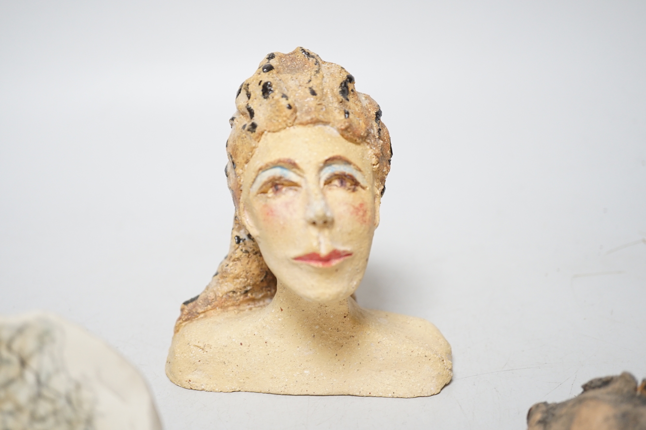 Coral Pearson-Revel (New Zealander) - Three works - A painted terracotta head and shoulders of a woman; a terracotta woman’s torso, dated 2007 and a half circle plaque, painted with a bust of a woman, each signed